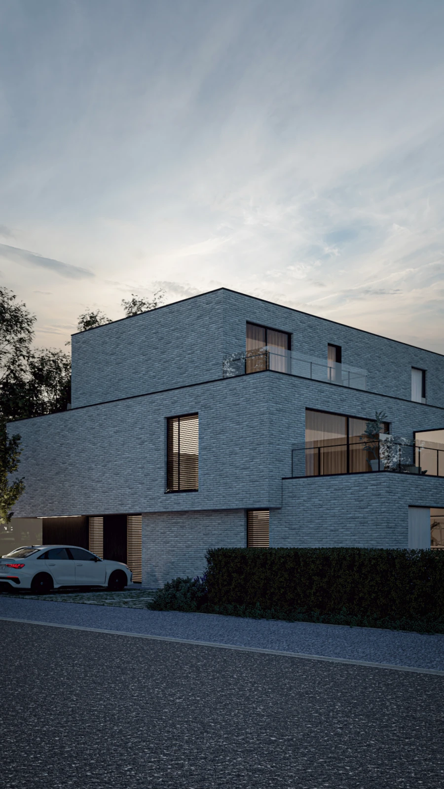 Luxe nieuwbouw appartementen met een minimalistisch gevelontwerp, dakterras en aangelegde groenstrook bij zonsondergang.